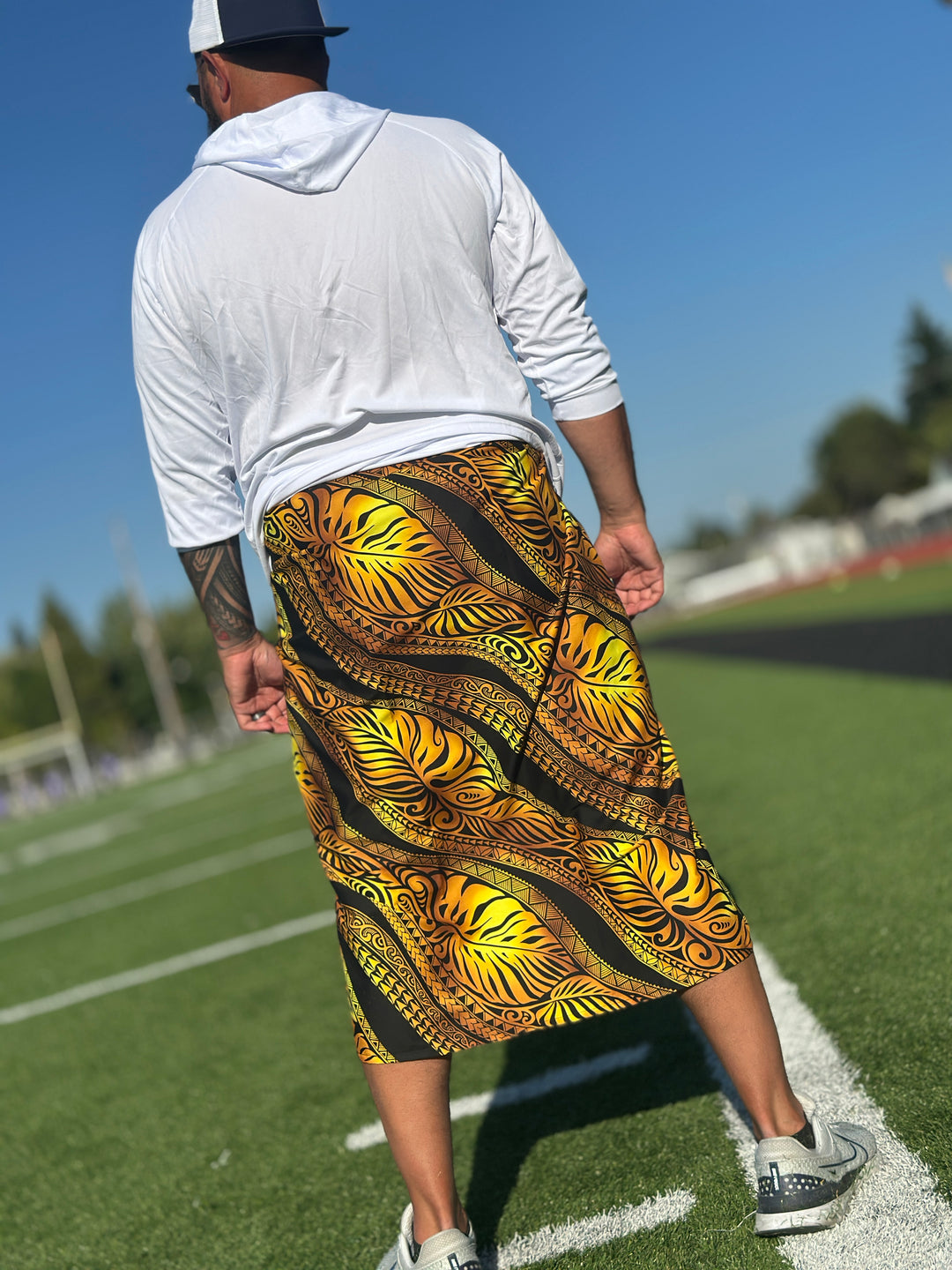Samoan man wearing a white long sleeved shirt and a gold and black lavalava