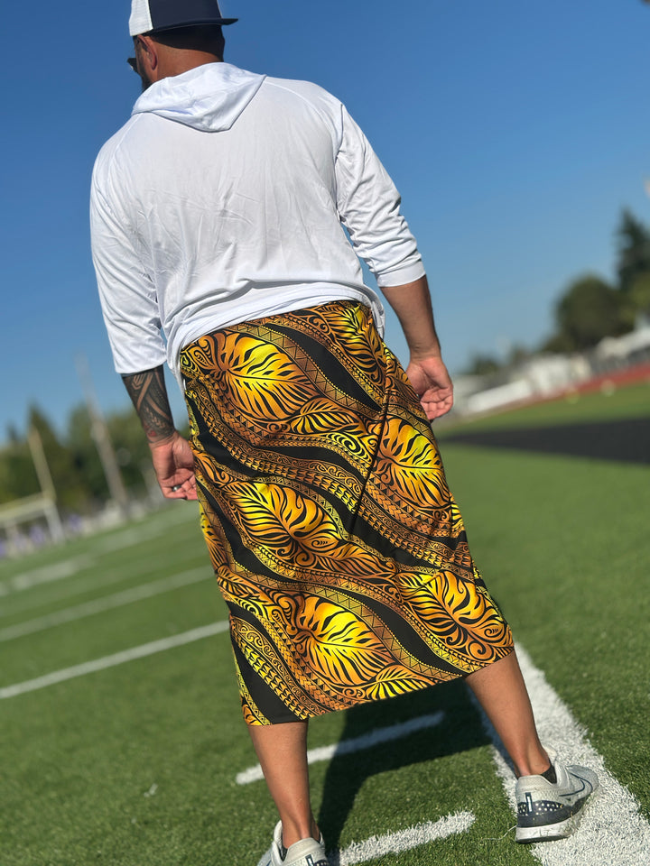 Samoan man wearing a white long sleeved shirt and a gold and black lavalava