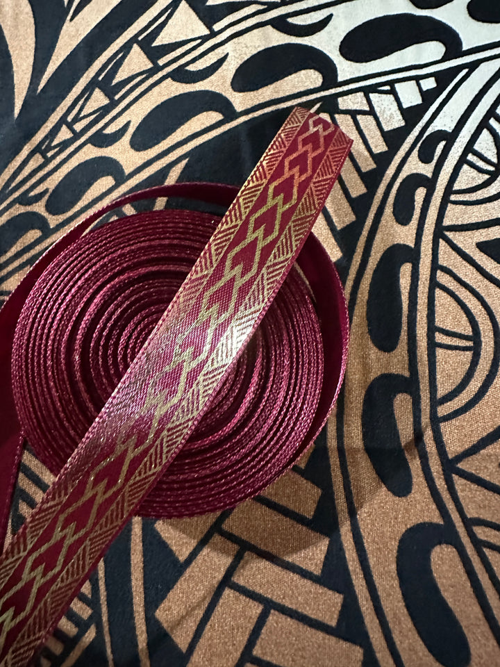 5/8” wide maroon satin ribbon with metallic gold tribal design