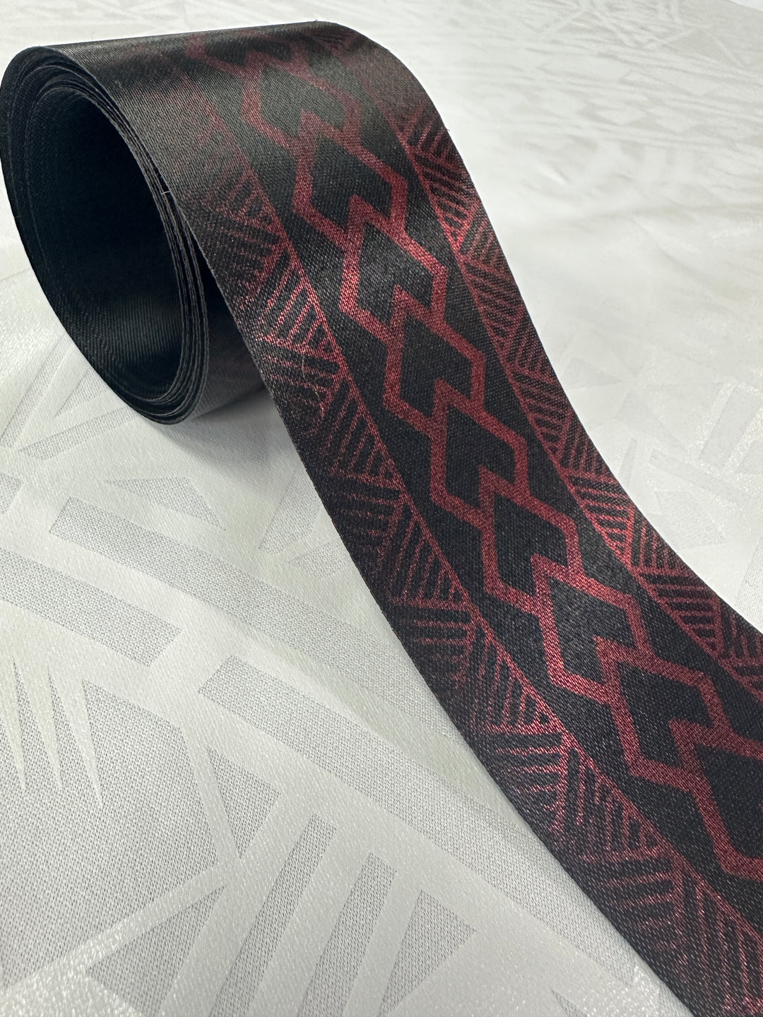 7 3/4 yards of 2 1/2” metallic red on black ribbon